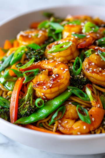 Colorful shrimp stir fry with noodles, fresh vegetables, quick meal for festivities, flavorful and nutritious option.