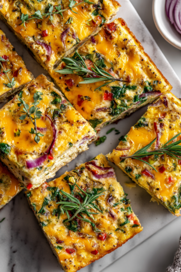 Sheet pan frittata recipe packed with vegetables and cheese, perfect for holiday gatherings
