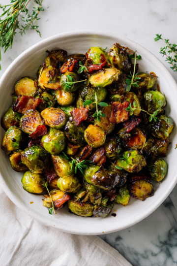 Maple roasted Brussels sprouts with bacon - a delicious, sweet, and savory side dish perfect for holiday gatherings and meals.