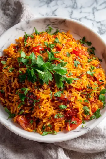 A vibrant Persian Tomato Rice dish featuring basmati rice, succulent tomatoes, and aromatic spices, perfect for holiday gatherings.